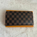 Pochette zippée motif carreaux beige et marron